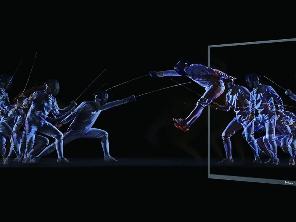 A fast-motion sports sequence rendered cleanly across a 120Hz outdoor television panel