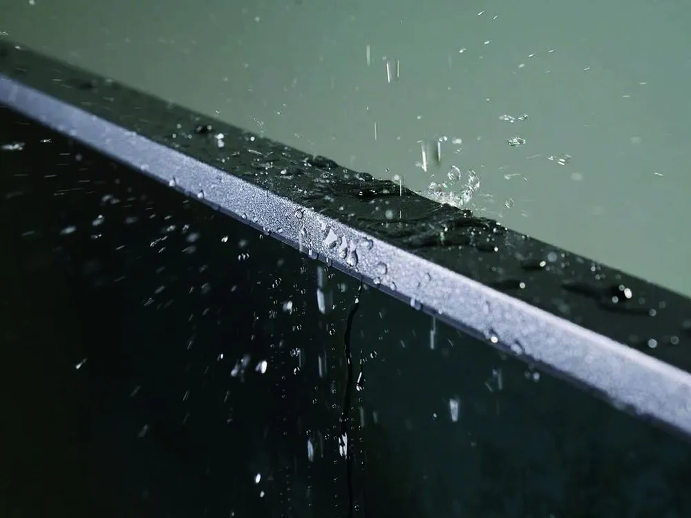 Water droplets beading on the sealed edge of a Sylvox outdoor television chassis