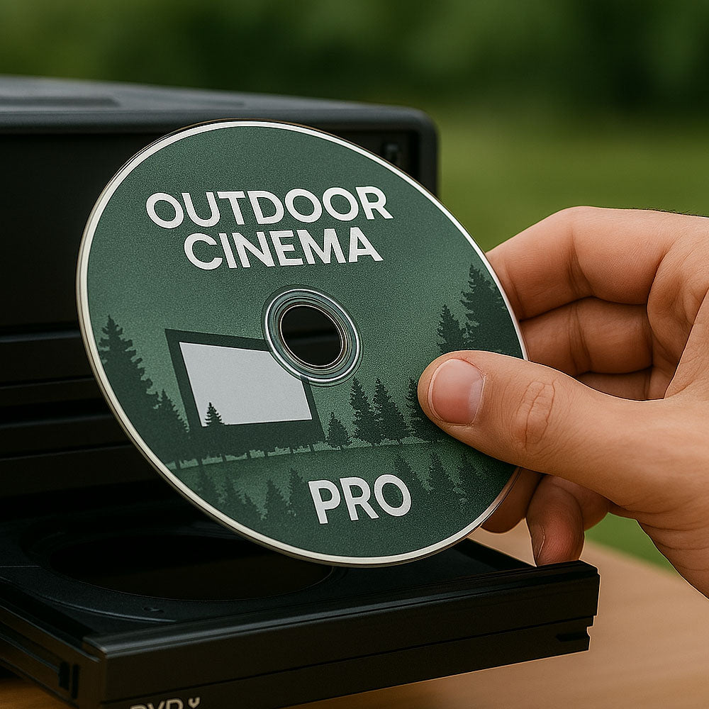 Hand holding an 'Outdoor Cinema Pro' DVD disc loading into a media system for outdoor theatre