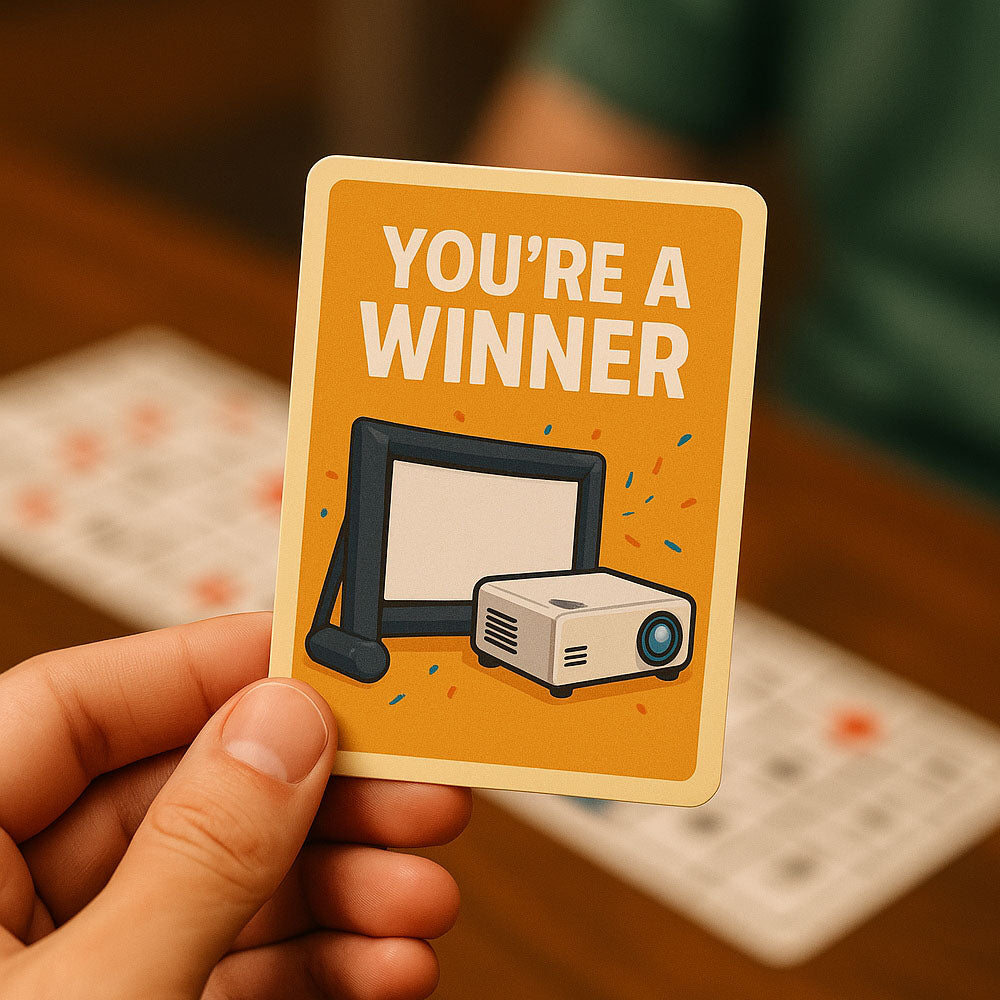 Hand holding a card with 'You're a Winner' text with projector and blow-up cinema screen illustration on an orange background.
